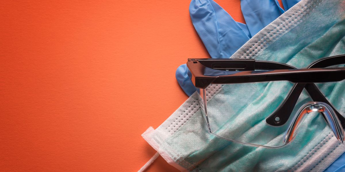 Photo of examination gloves, a mask and safety glasses